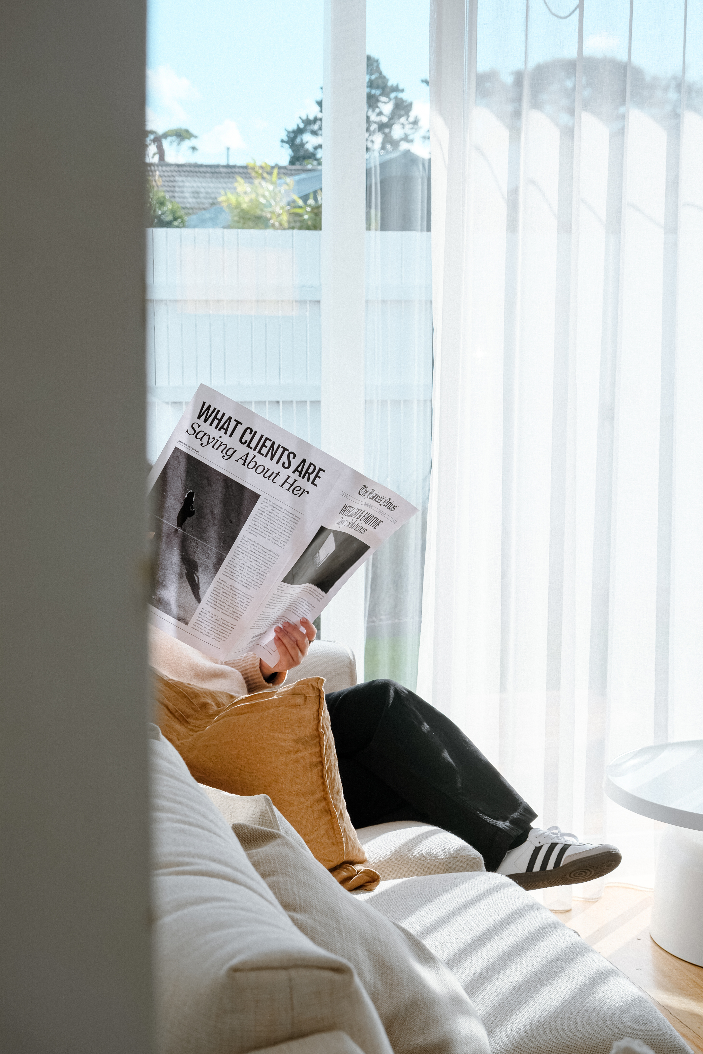 Portrait of a man with brown hair and glasses on a flat gray background.