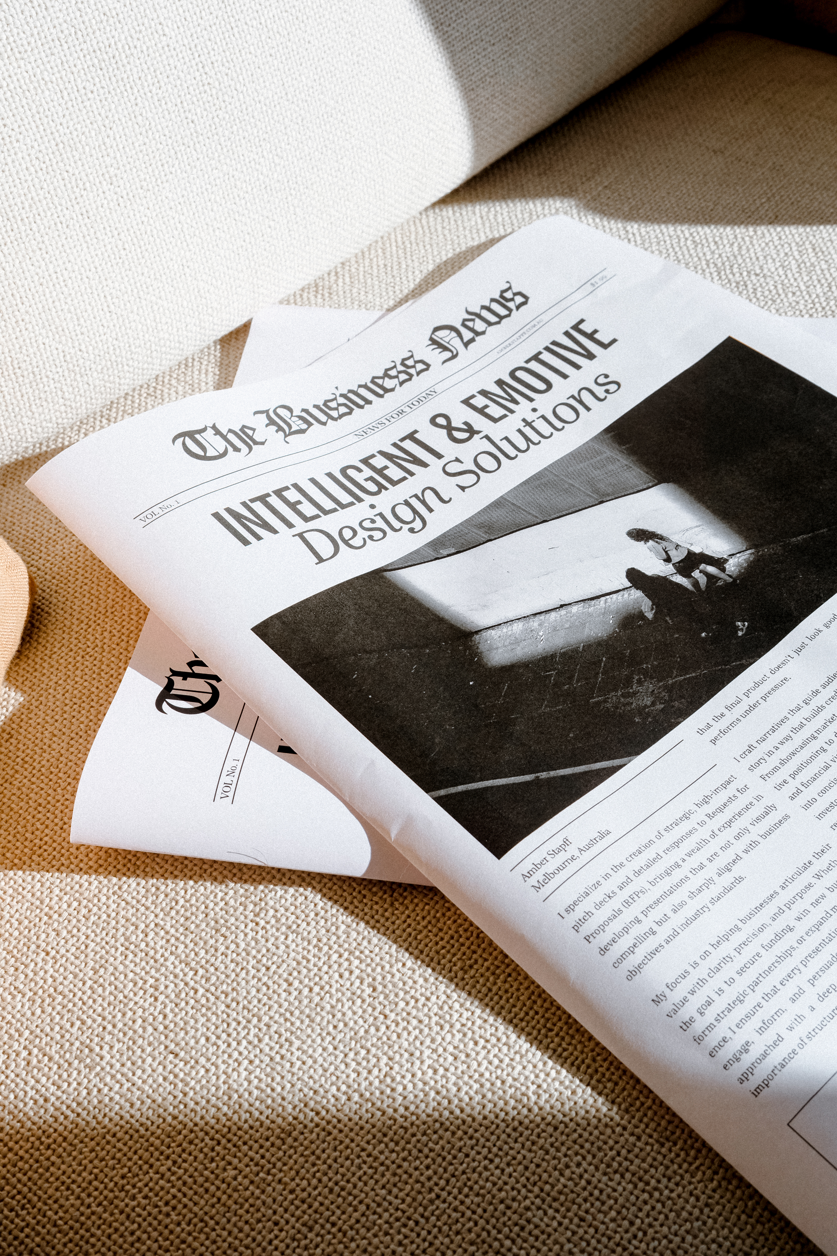 Portrait of a man with brown hair and glasses on a flat gray background.